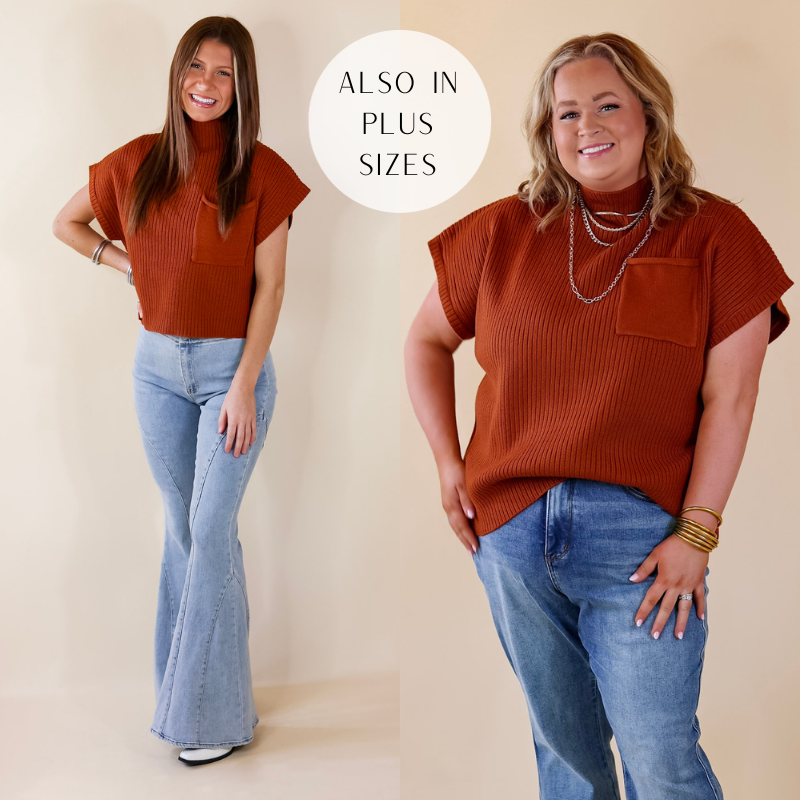 Model is wearing a copper cropped sweater with a front pocket. Model has paired the top with denim jeans, white booties, and silver tone jewelry. 