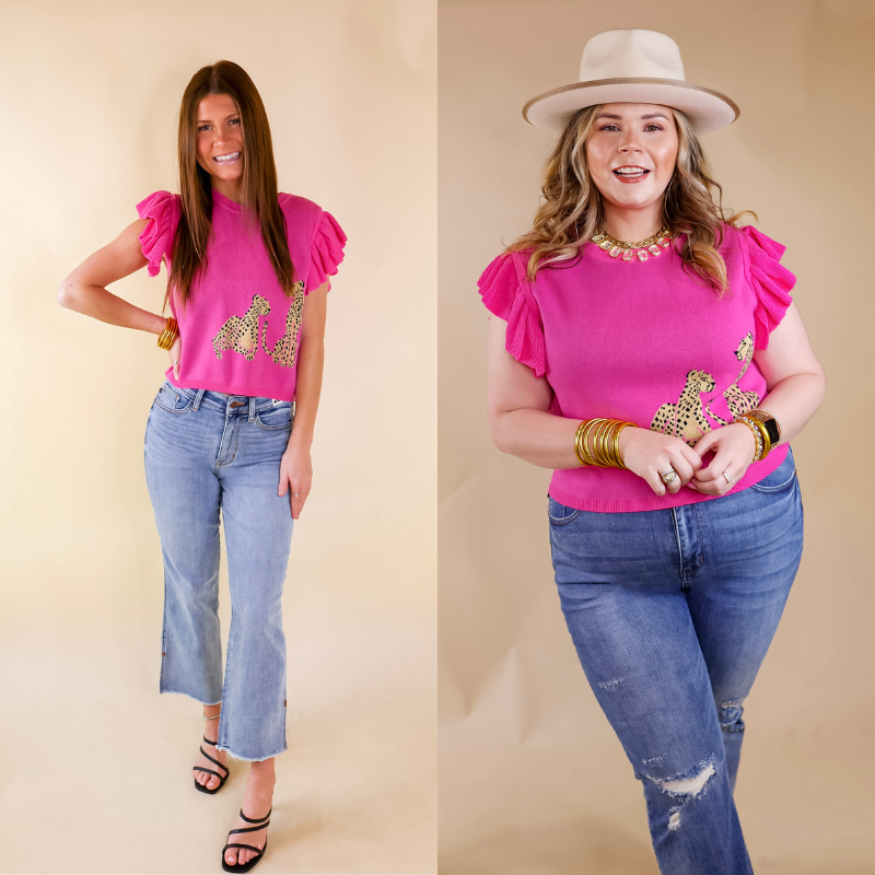 Model is wearing a ruffle cap sleeve cropped sweater in hot pink. This sweater has two cheetahs printed on the left bottom corner. Model has this top paired with light wash jeans, black heels, and gold jewelry.
