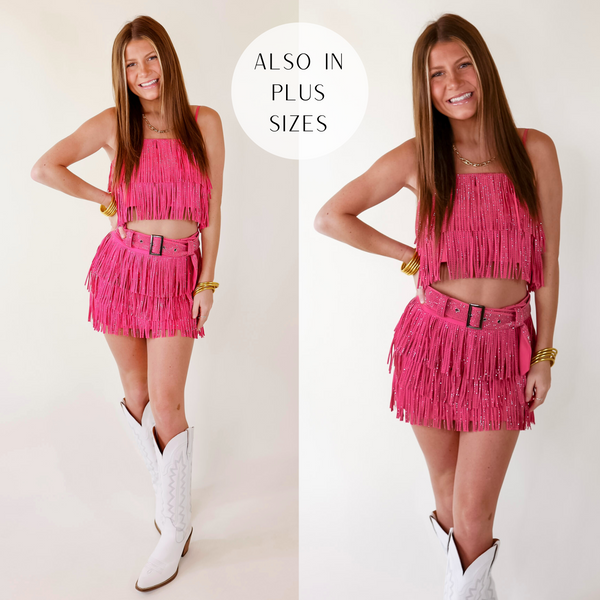 Model is wearing a pink skort with crystal fringe throughout and a crystal belt