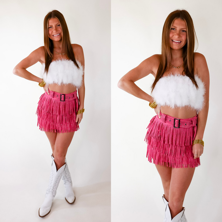 Model is wearing a white feather strapless cropped top