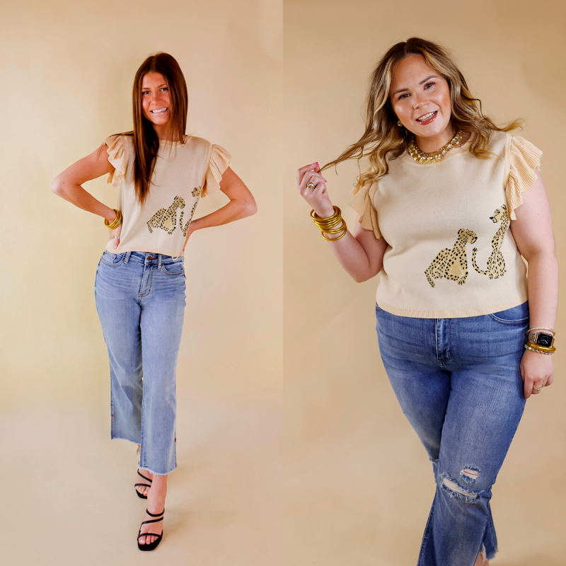 Model is wearing a ruffle cap sleeve cropped sweater in beige. This sweater has two cheetahs printed on the left bottom corner. Model has this top paired with light wash jeans, black heels, and gold jewelry.