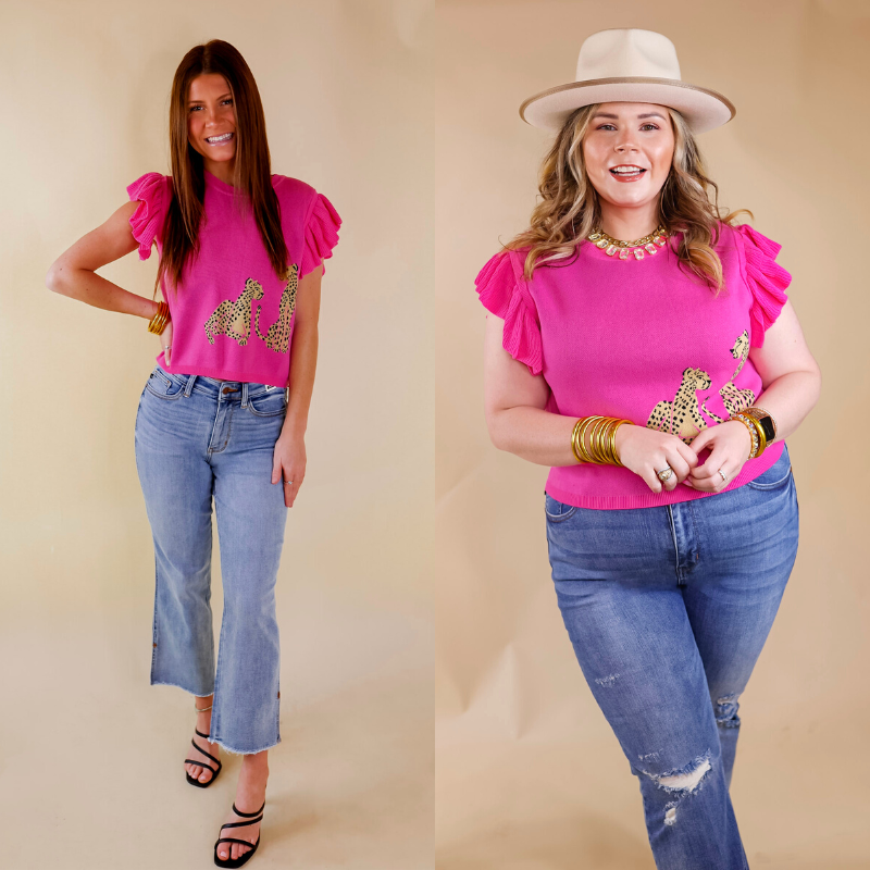 Model is wearing a ruffle cap sleeve cropped sweater in hot pink. This sweater has two cheetahs printed on the left bottom corner. Model has this top paired with light wash jeans, black heels, and gold jewelry.