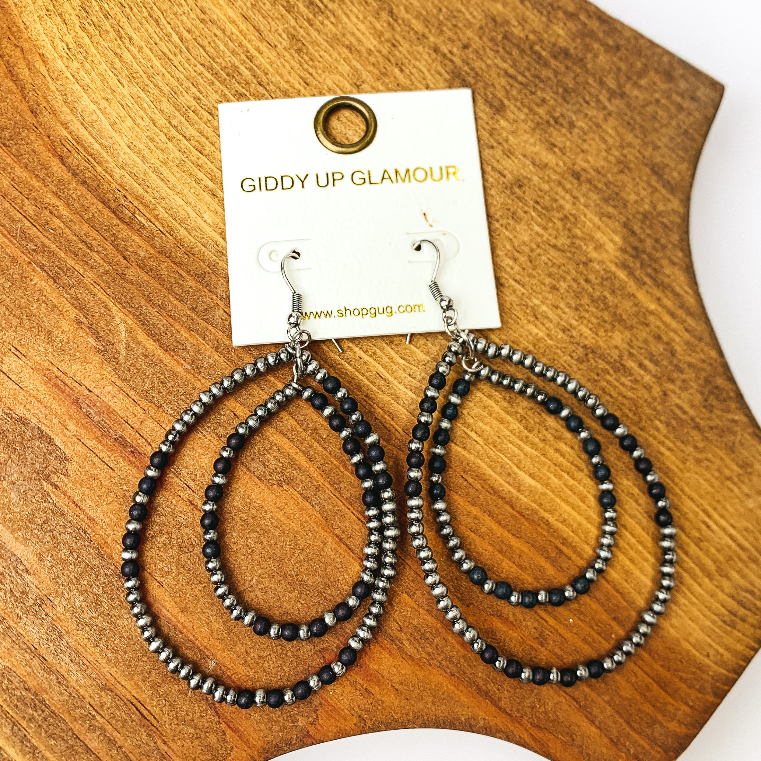 Beaded Double Drop Earrings in Silver Tone and Black. Pictured on wood piece.