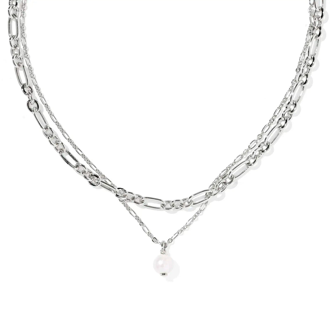 Layered silver chain necklace with a pearl pendant on a white background