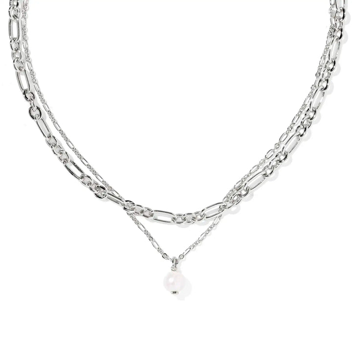 Layered silver chain necklace with a pearl pendant on a white background