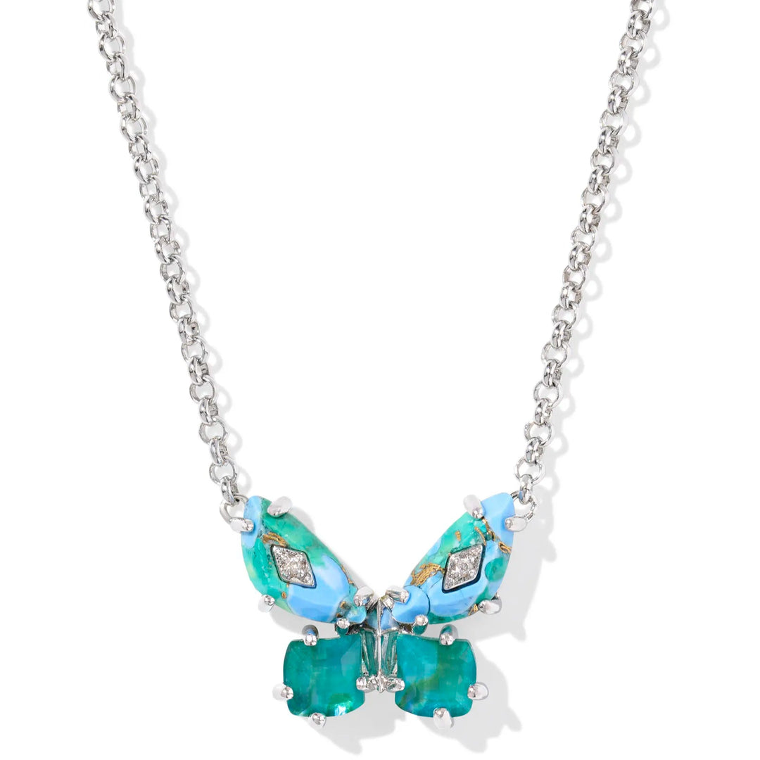 A solid white background with a silver chain necklace and a butterfly pendant hanging from the end. The butterfly is in the color bright aqua mix (shades of blue and green) and has crystals on the wings.