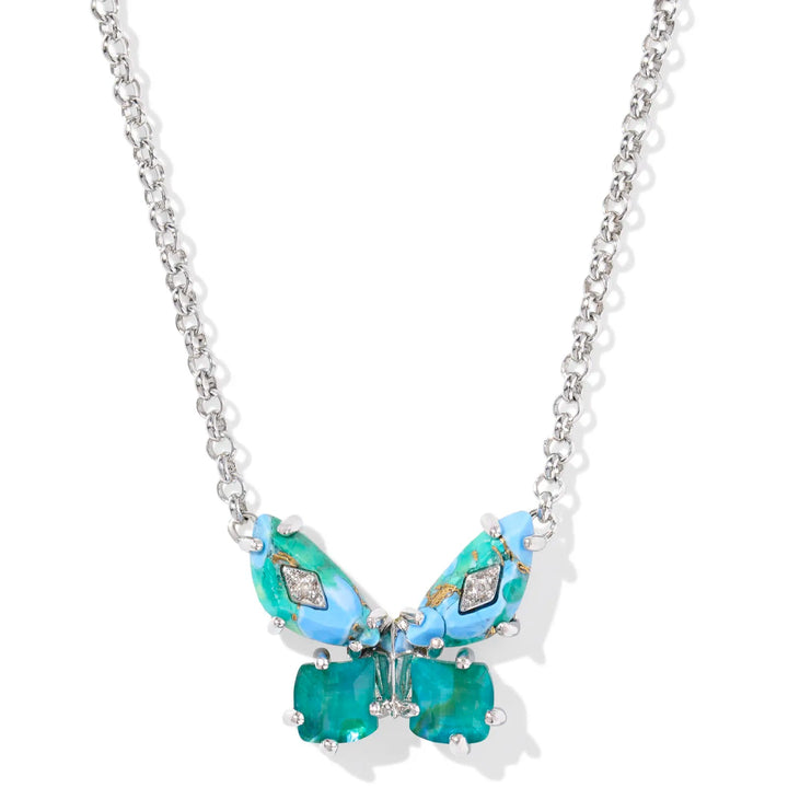 A solid white background with a silver chain necklace and a butterfly pendant hanging from the end. The butterfly is in the color bright aqua mix (shades of blue and green) and has crystals on the wings.