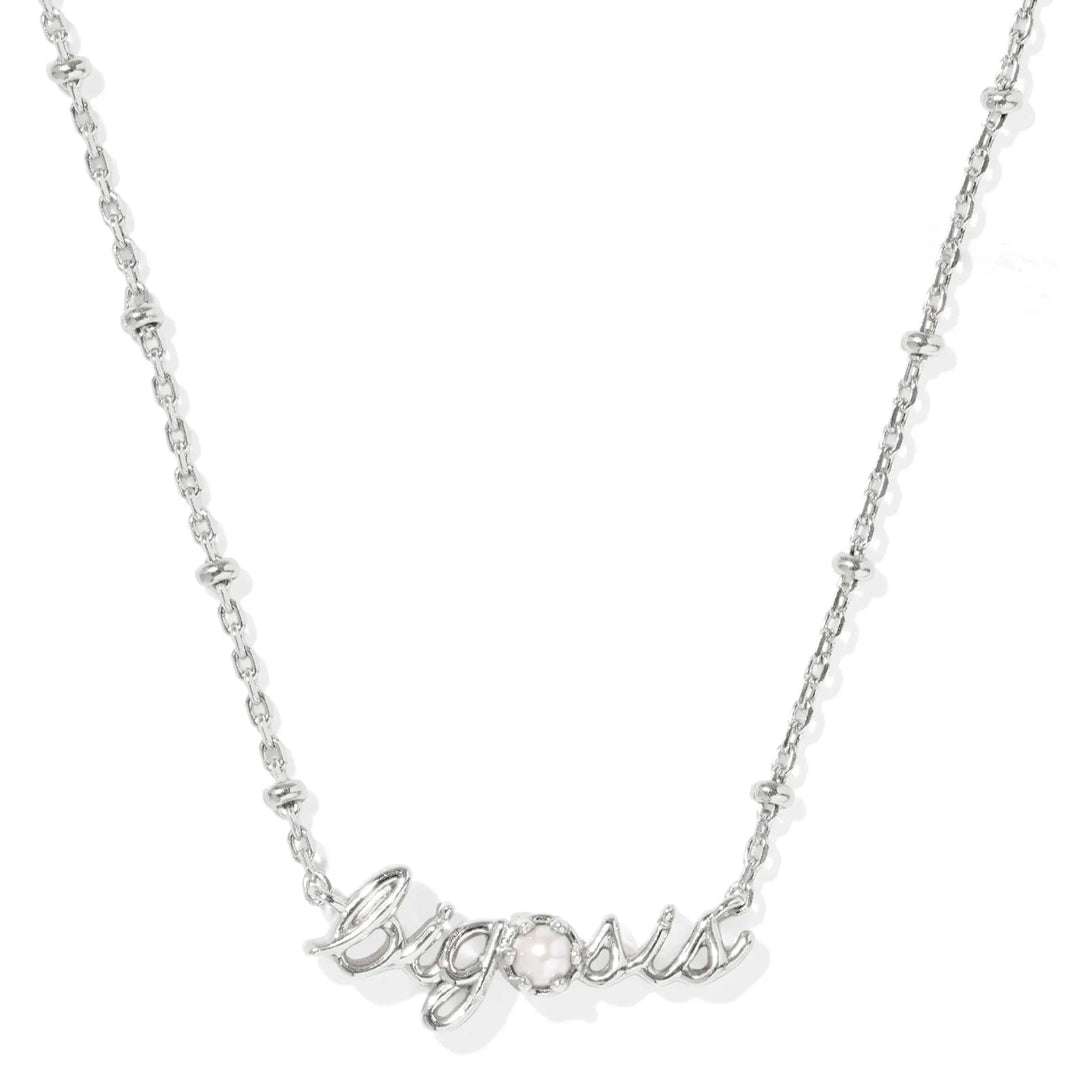 Silver necklace with 'big sis' pendant on a white background