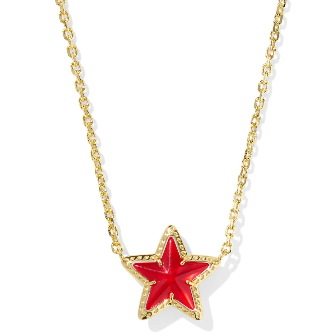 Solid white background with a gold chain necklace and a ed star pendant. 