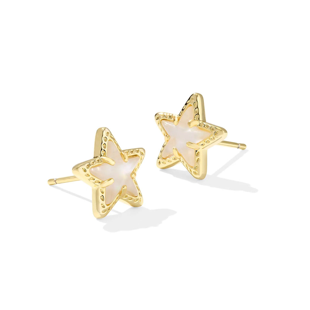 A solid white background with gold star stud earrings in ivory mother-of-pearl. 