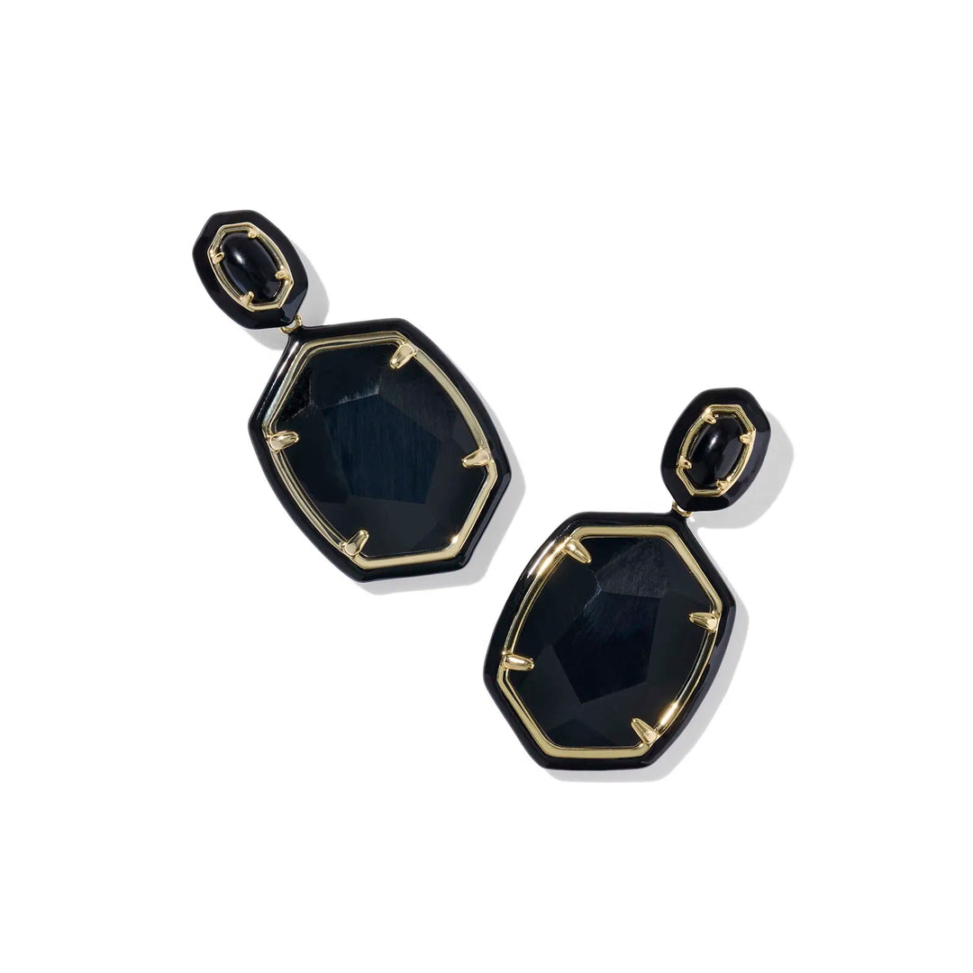 Black and gold earrings on a white background