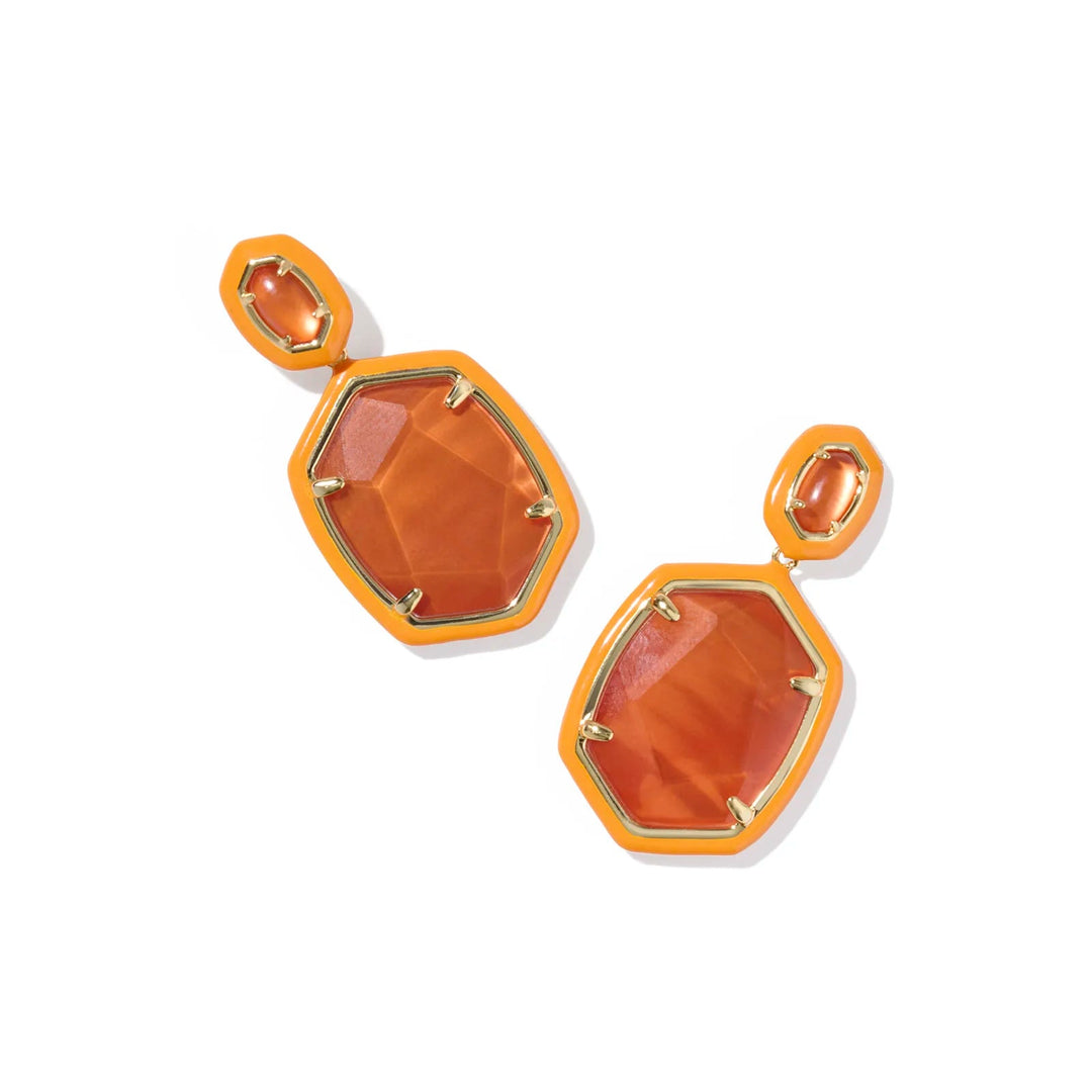 Pair of earrings with orange stone and gold accents on a white background