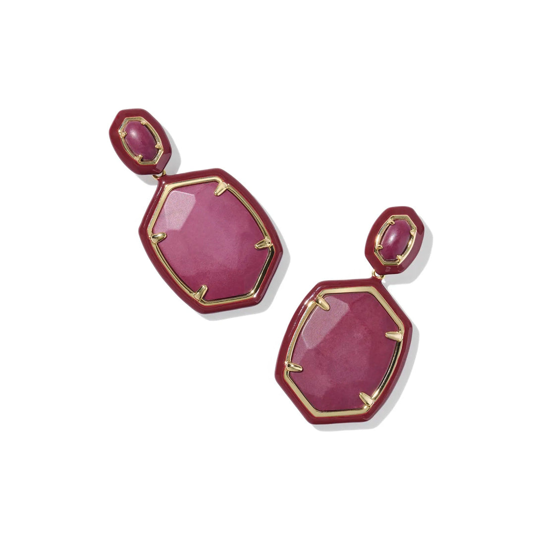 Pair of maroon earrings with gold accents on a white background