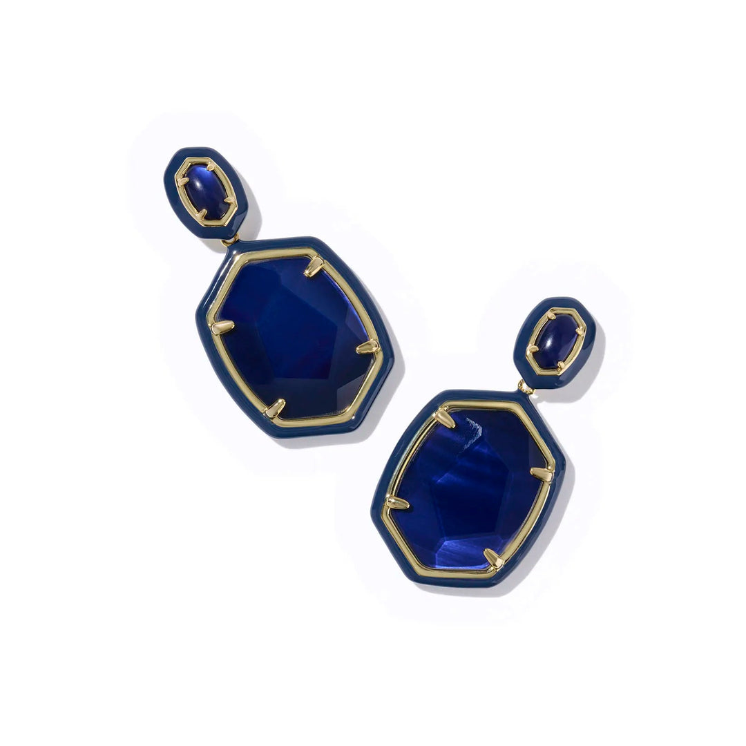 Pair of blue earrings with gold accents on a white background