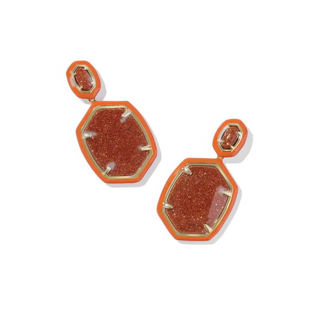 Hexagonal earrings with goldstone-like material on a white background