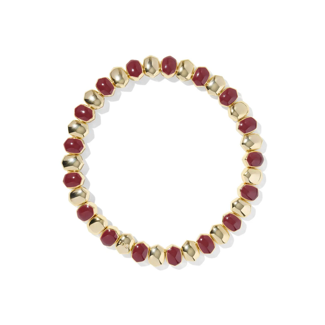 Bracelet with gold and burgundy beads on a white background