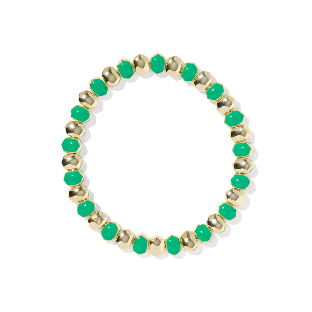Bracelet with green beads and gold accents on a white background