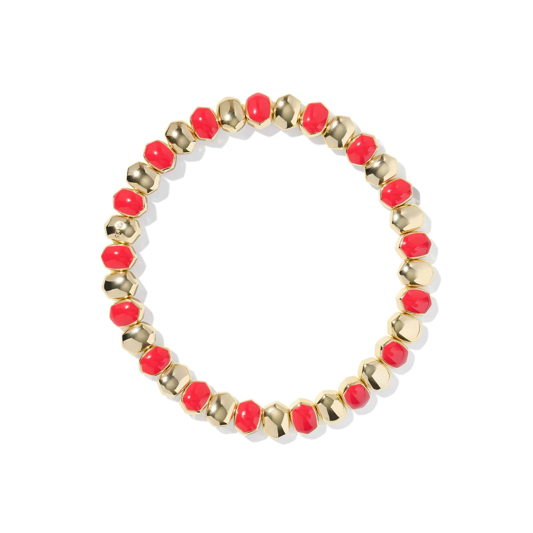 Bracelet with red beads and gold accents on a white background