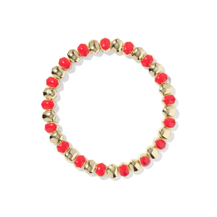 Bracelet with red beads and gold accents on a white background