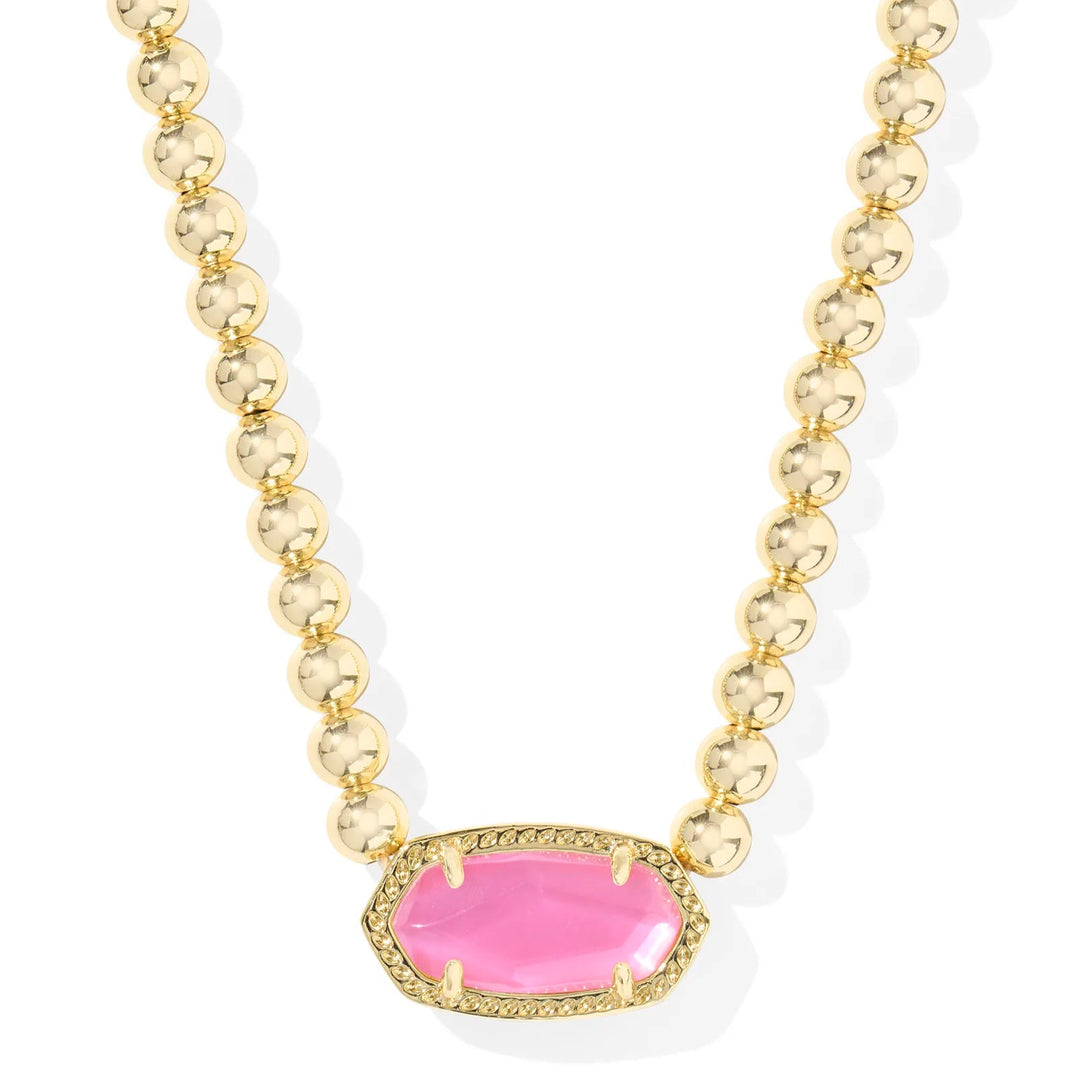 A solid white background with a gold beaded necklace and kendra scott's signature stone shape in the color azalea illusion