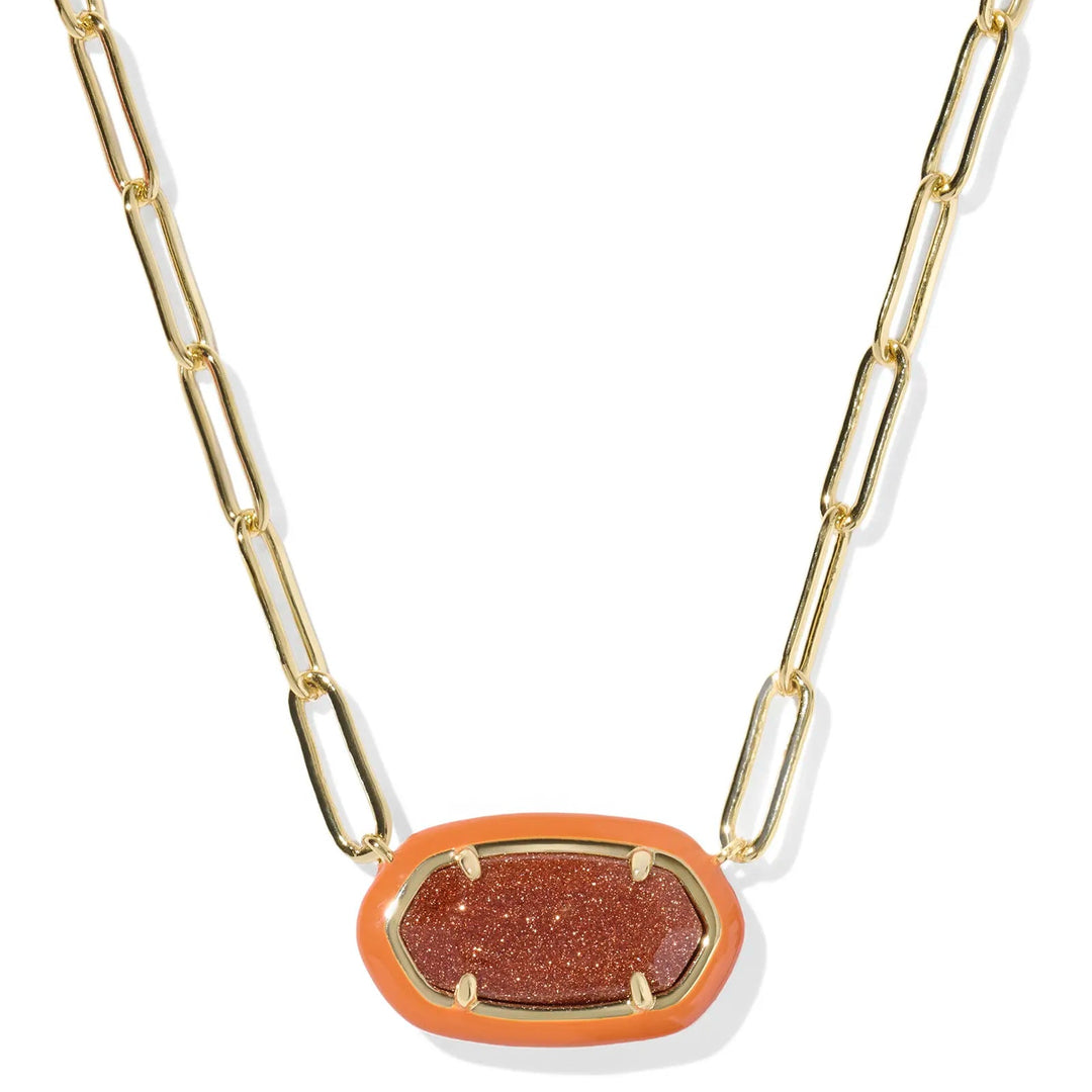 Gold chain necklace with a orange sparkle pendant on a white background