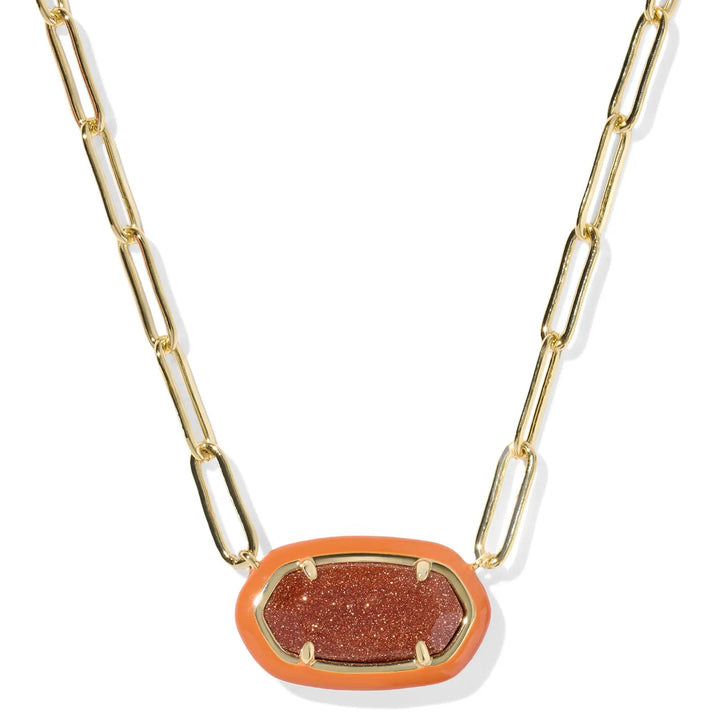 Gold chain necklace with a orange sparkle pendant on a white background
