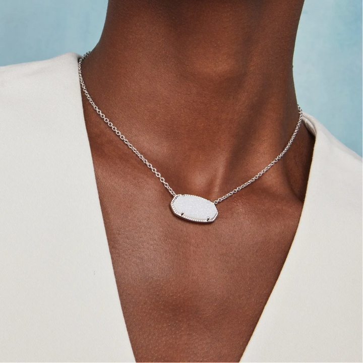 Woman wearing a necklace with a blue background