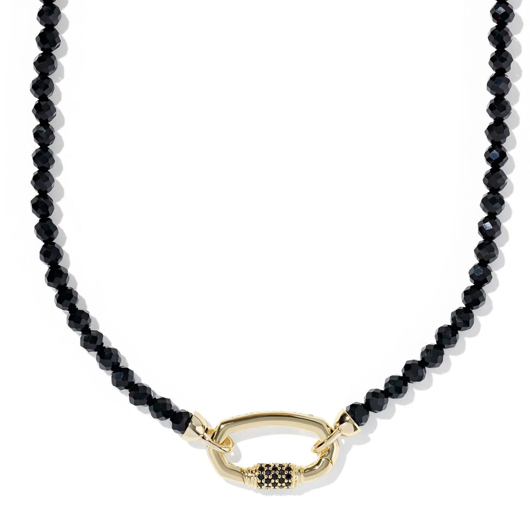 Black beaded necklace with a gold clasp on a white background