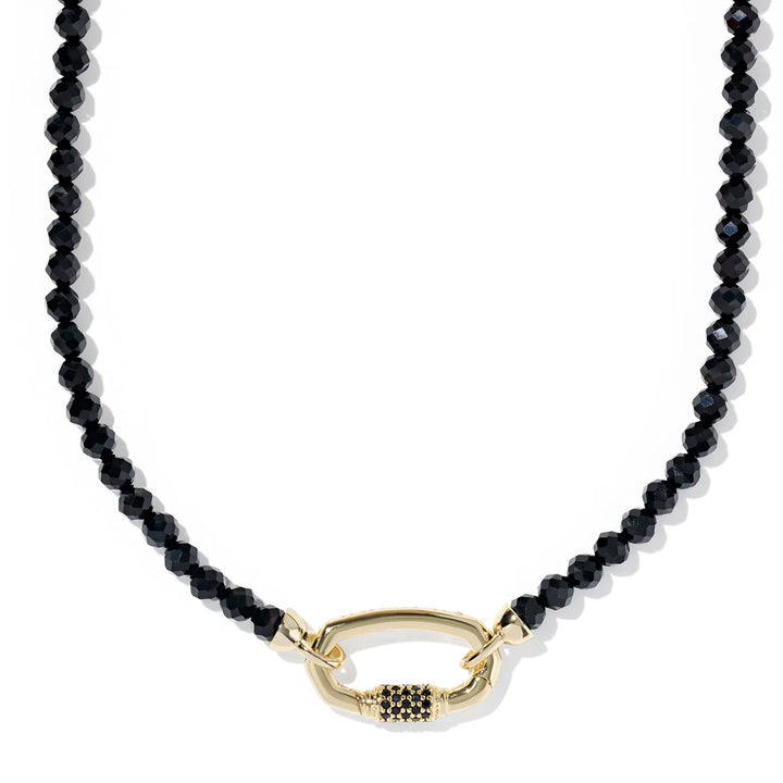 Black beaded necklace with a gold clasp on a white background