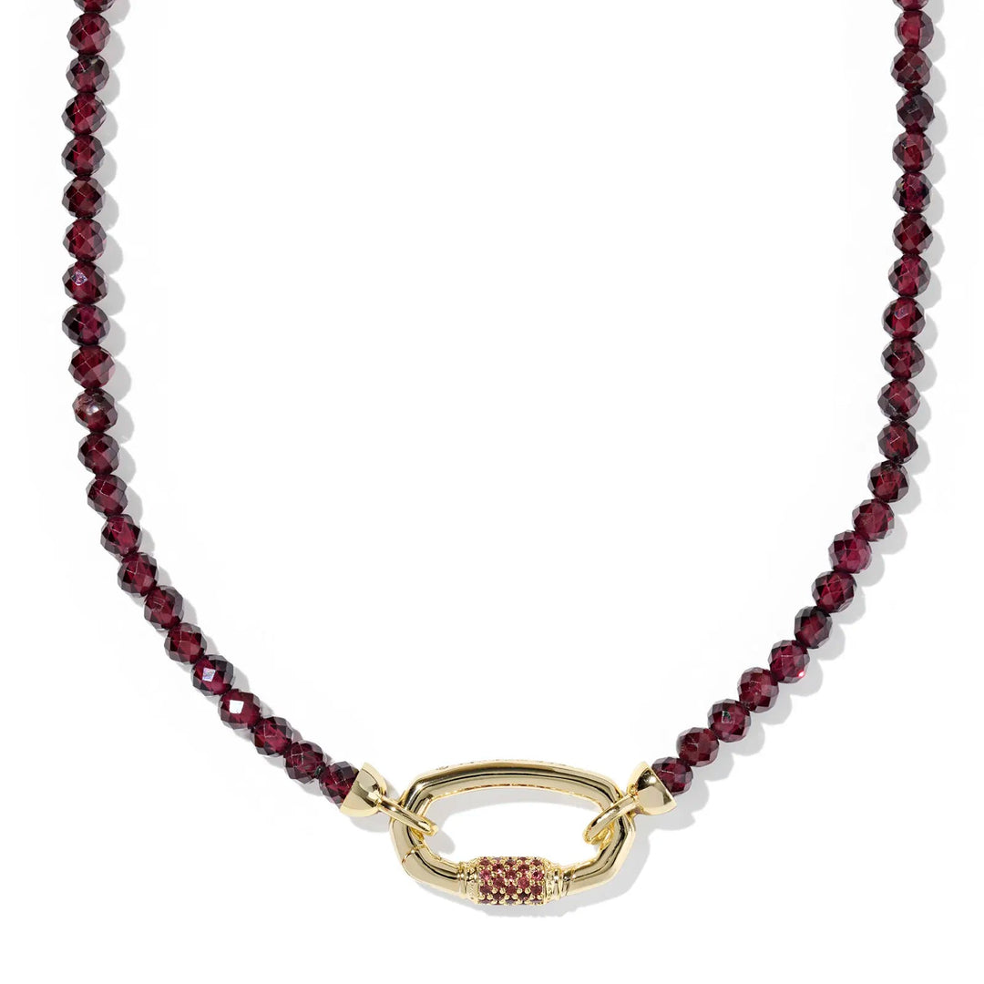 Necklace with red beads and a gold clasp on a white background