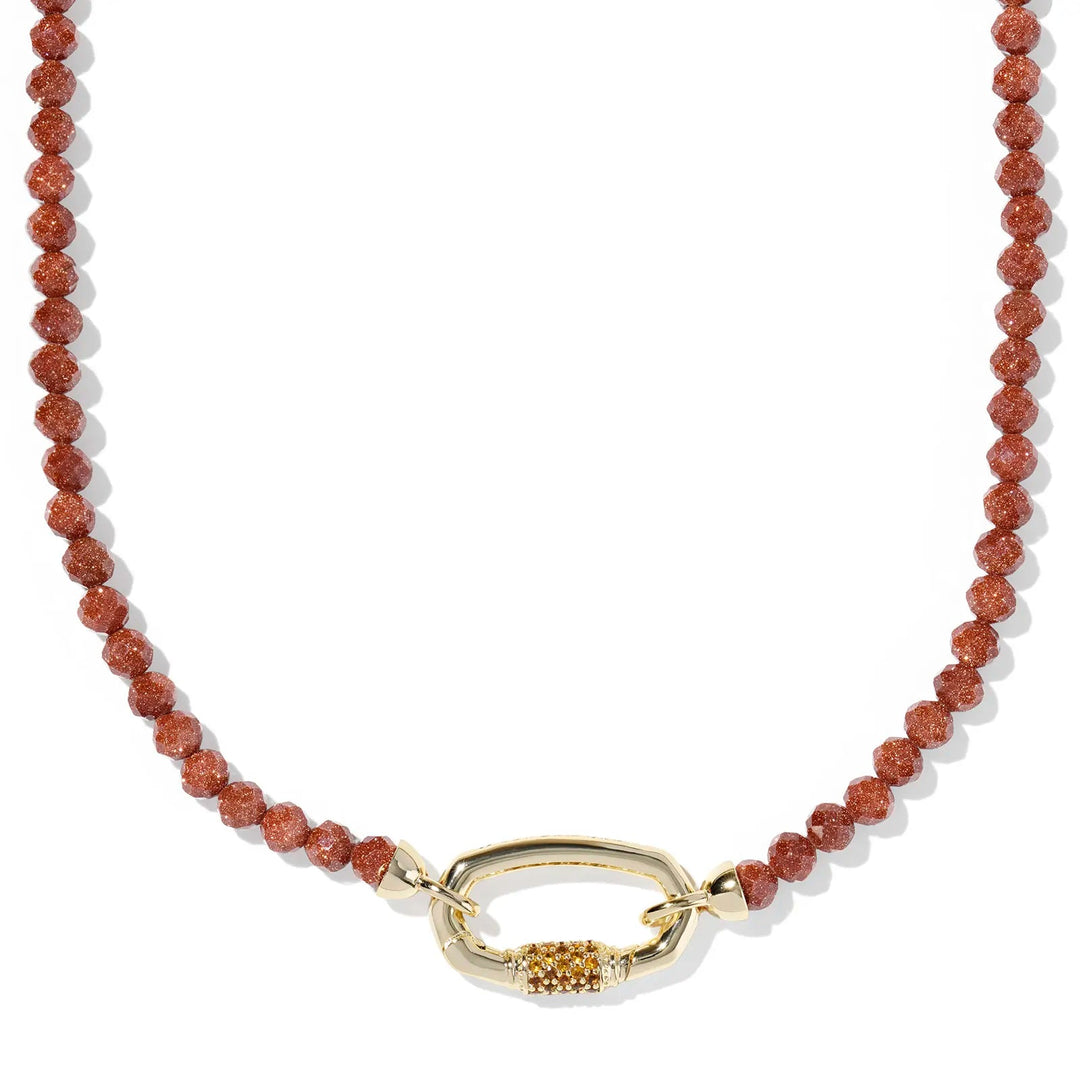 Necklace with orange goldstone beads and a gold clasp on a white background