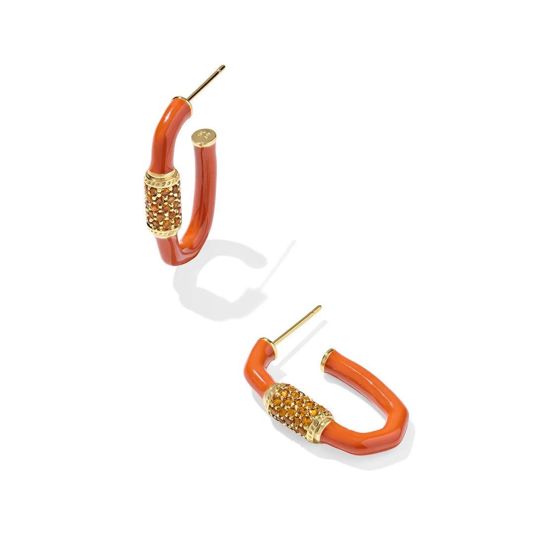 Pair of orange hoop earrings with gold accents on a white background