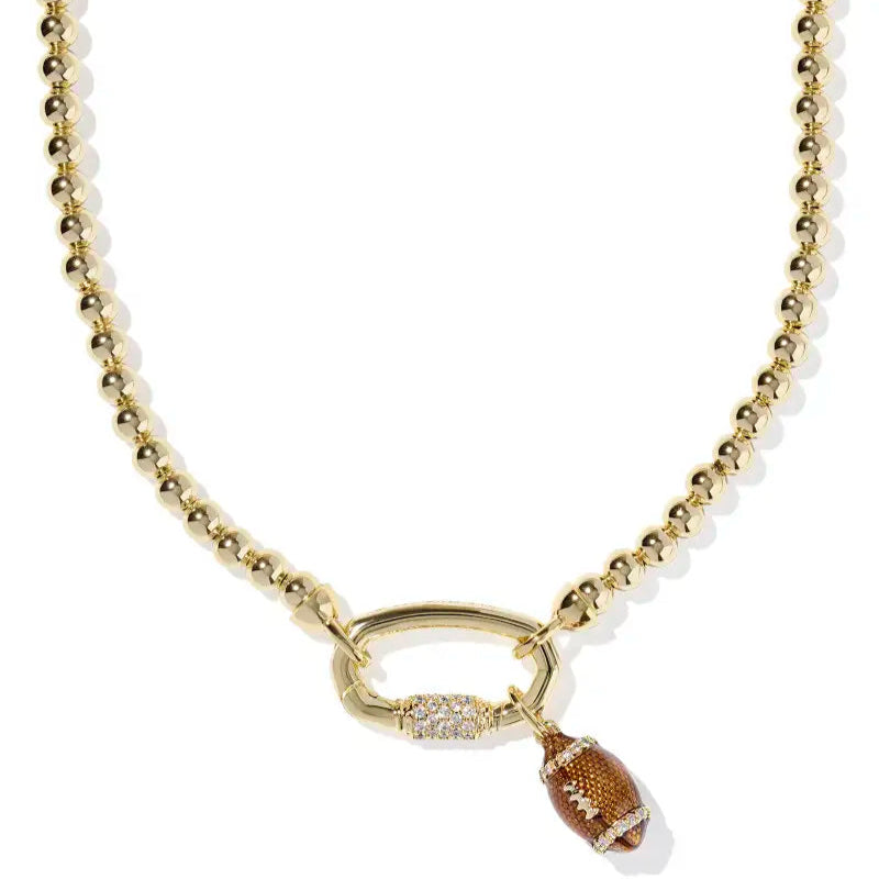 Gold necklace with a football pendant on a white background