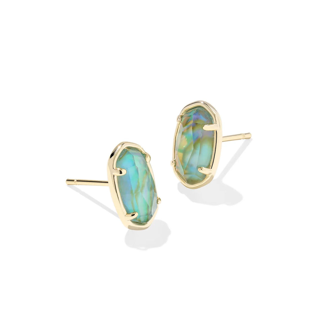 A solid white background with a set of earrings in gold with a center stone of Deep Aqua Illusion.