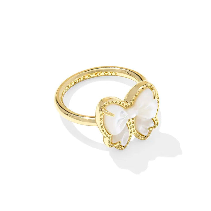 Gold ring with a bow design on a white background