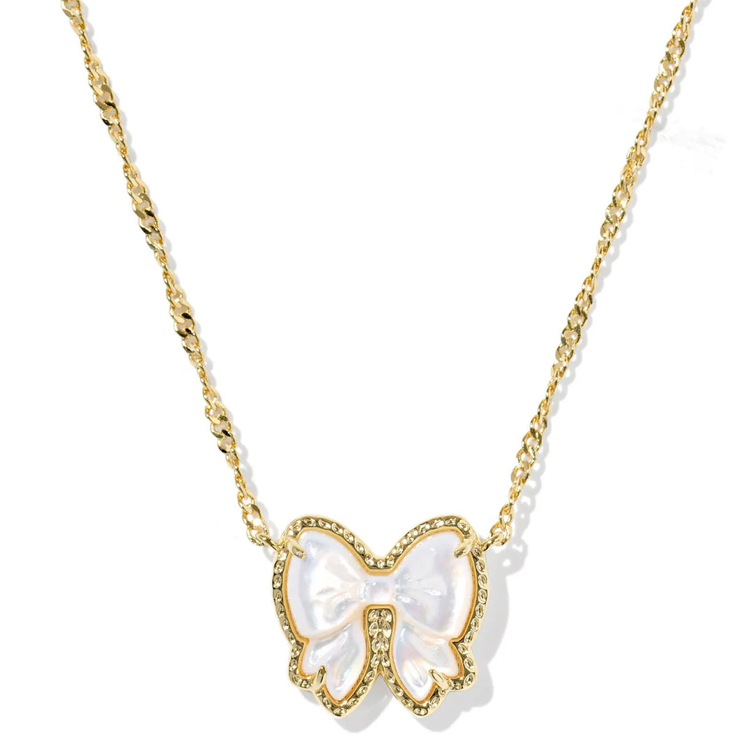 Gold bow necklace on a white background