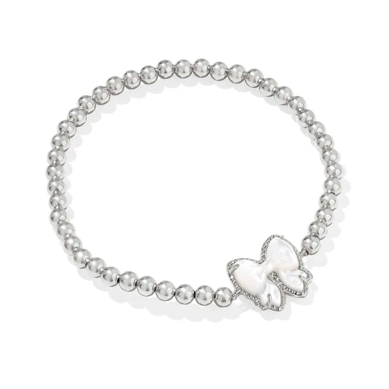 Pearl bracelet with a bow charm on a white background