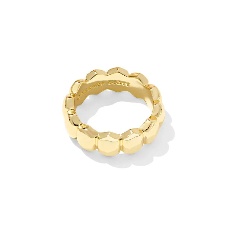 Gold ring with beaded design on a white background