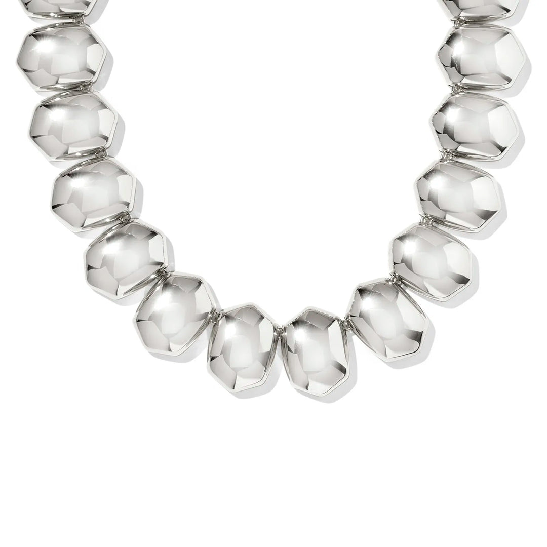 Silver beaded necklace on a white background