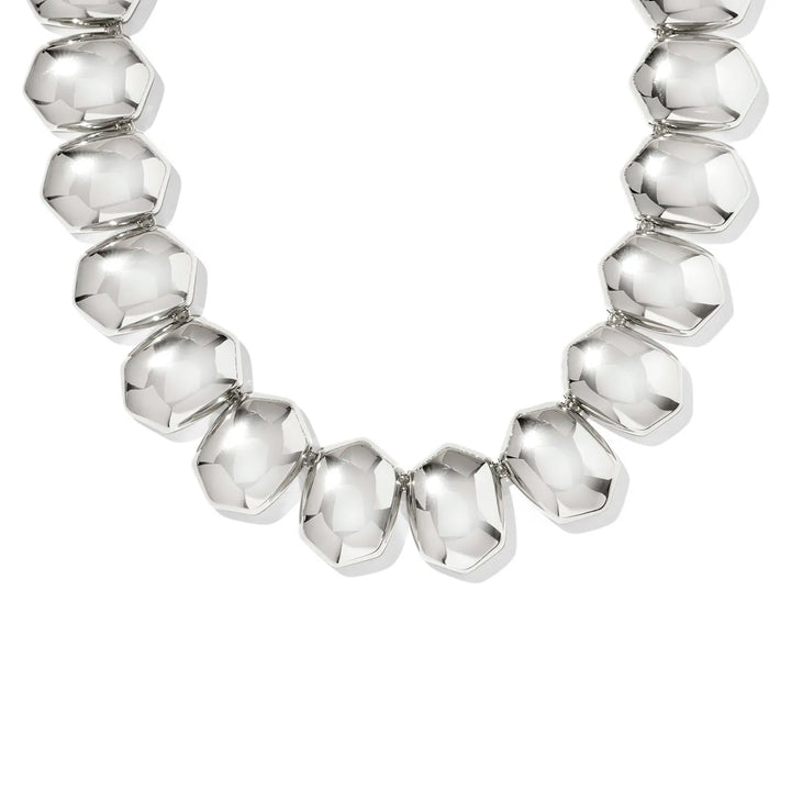 Silver beaded necklace on a white background