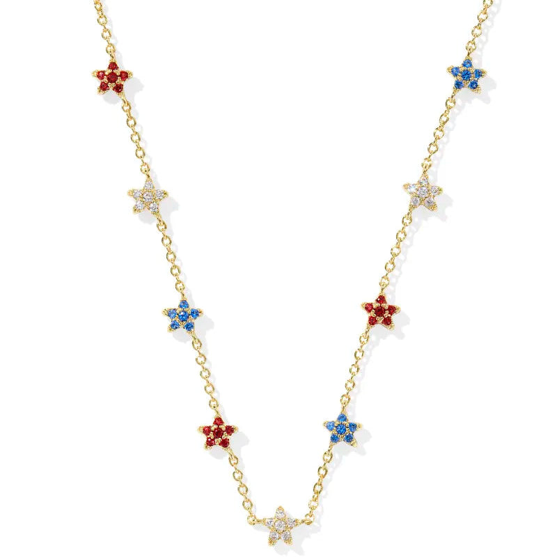 A solid white background. Gold strand necklace with stars in red, white, blue crystal.