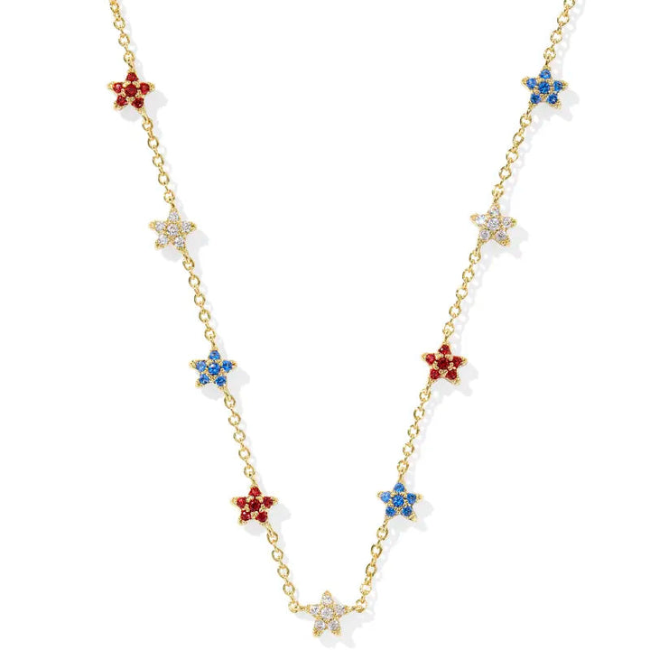 A solid white background. Gold strand necklace with stars in red, white, blue crystal.