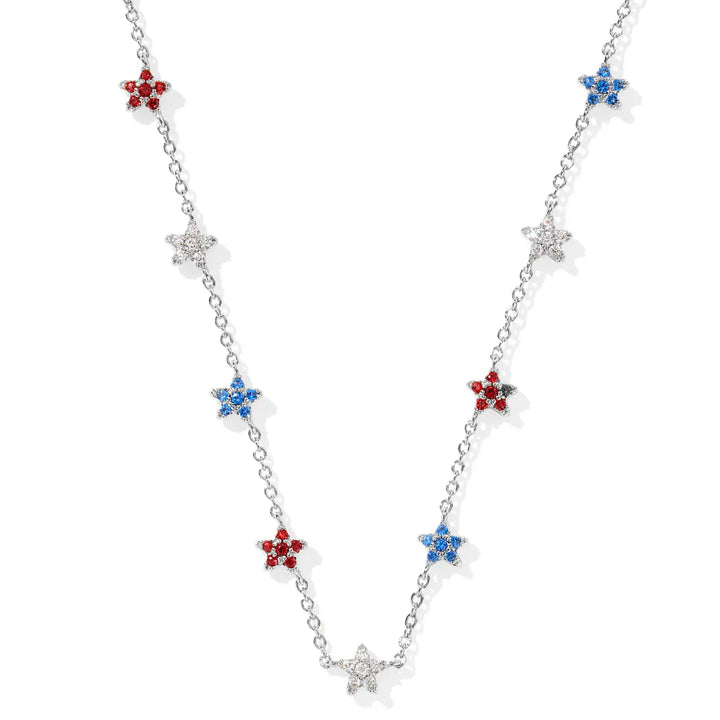 A solid white background and a silver chain necklace with stars on them, each star is covered in crystals and is either red, white or blue. 