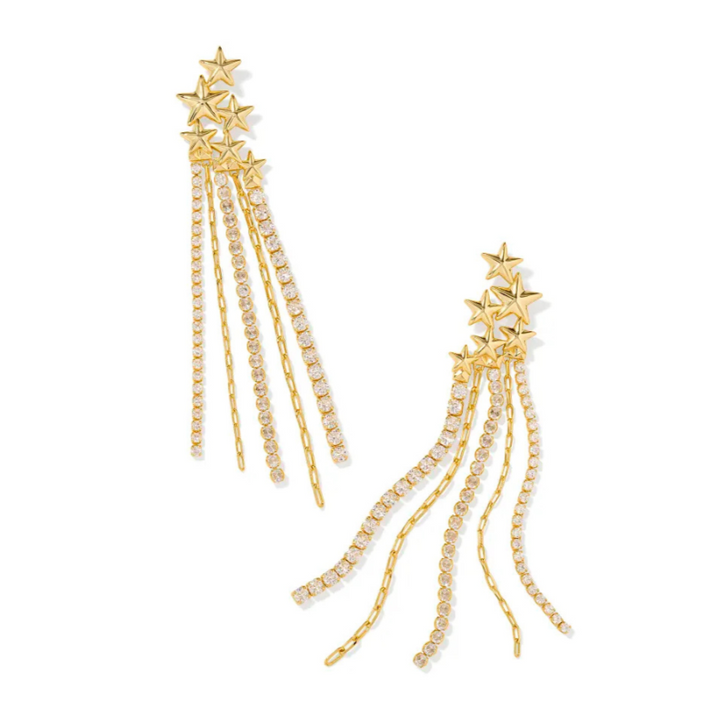 A solid white background. Gold statement earrings that mimic shooting stars with white crystals 