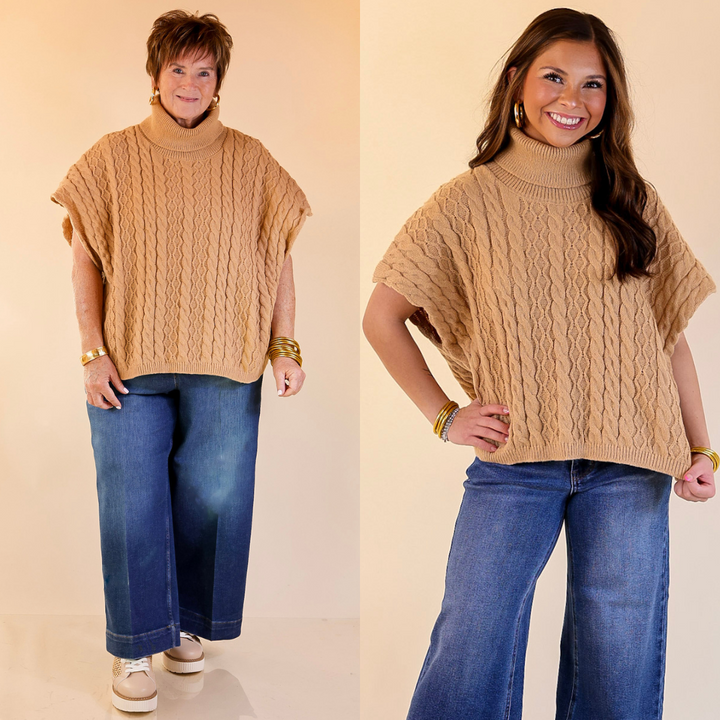 Two women wearing taupe turtleneck sweater tops and blue jeans on a beige background