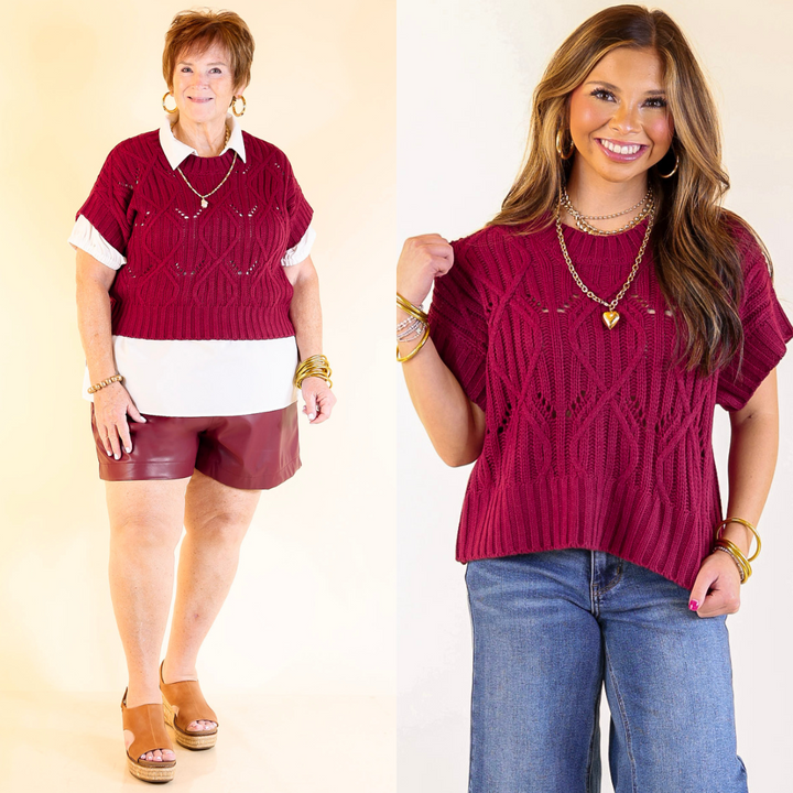 Two women wearing maroon sweater tops with different outfits on a plain background
