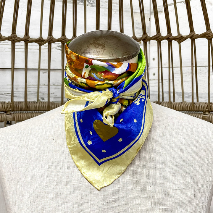 Colorful scarf draped over a mannequin bust with a wicker chair in the background