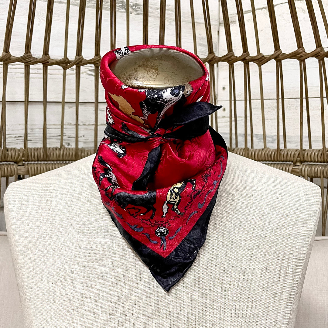 Mannequin wearing a red and black patterned bandana on a wicker chair.