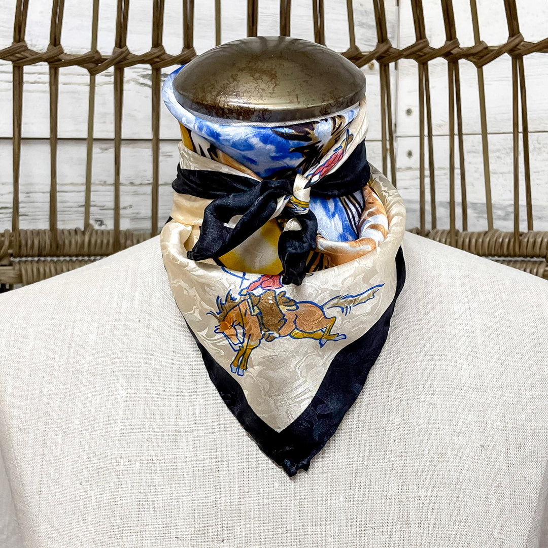 Mannequin head with a colorful scarf draped around its neck against a wicker chair background.