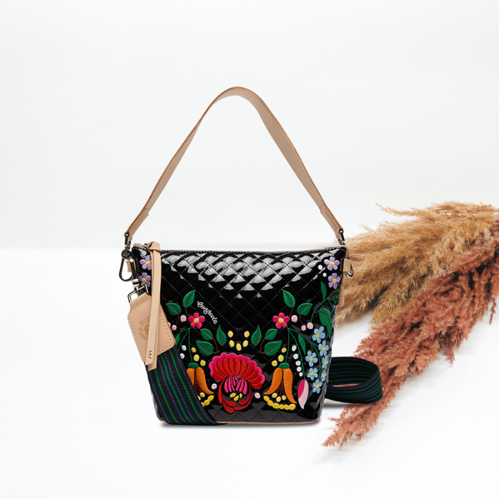 Black handbag with colorful floral embroidery on a white background